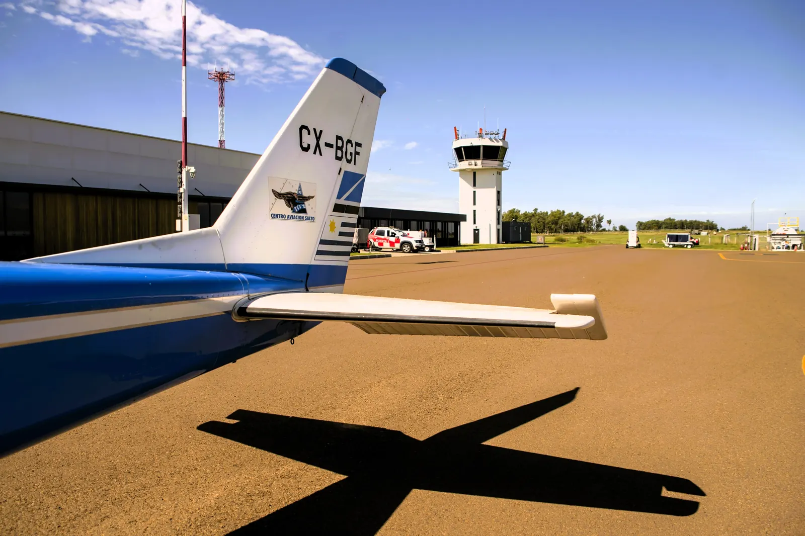 Light aircraft and control tower at Salto airport, Uruguay