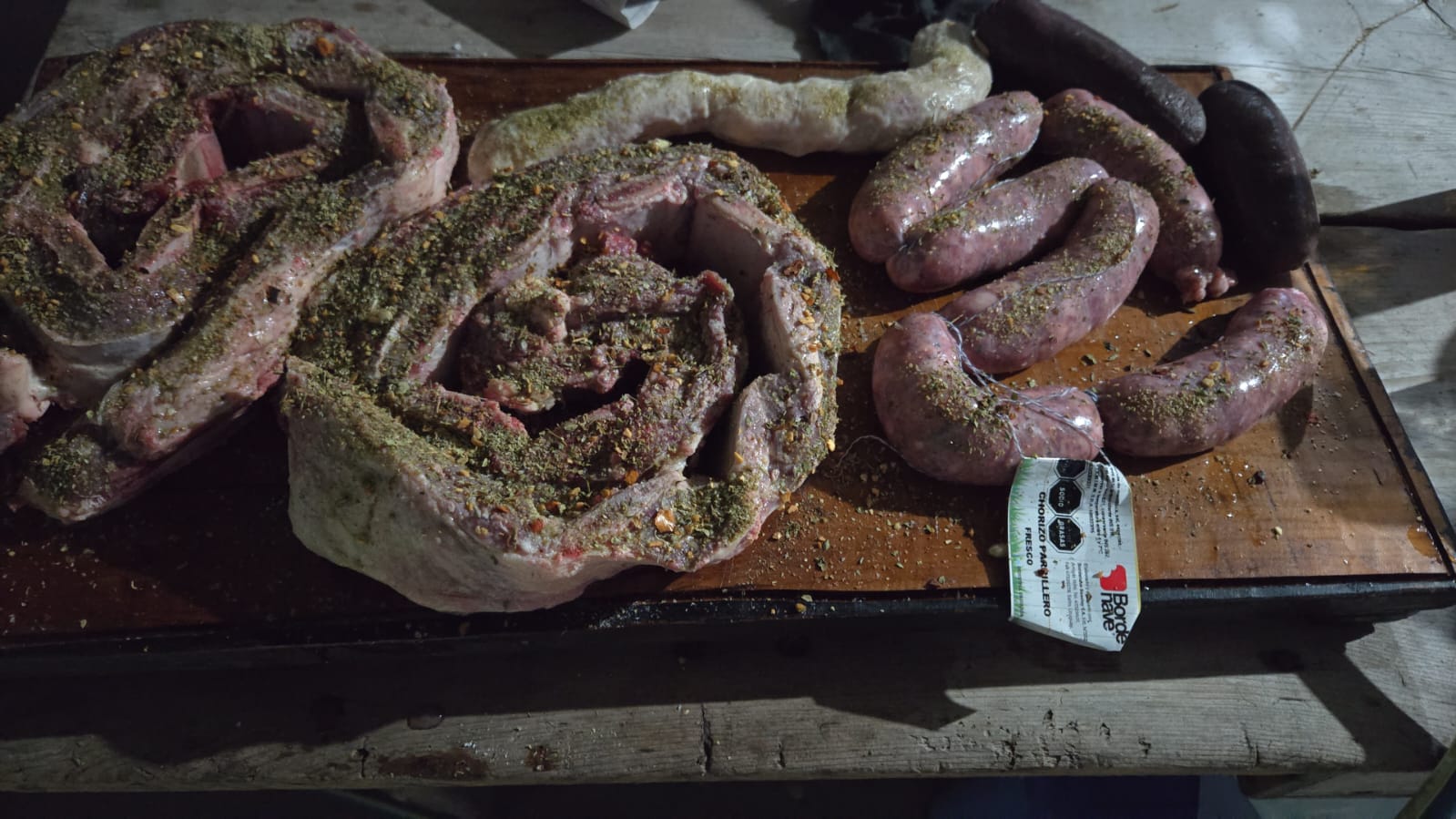 Seasoned ribs, chorizos and morcillas on the cutting board before an asado in Salto, Uruguay
