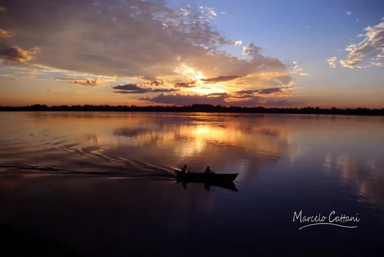 A small boat crossing the Rio Uruguay at first light near Salto