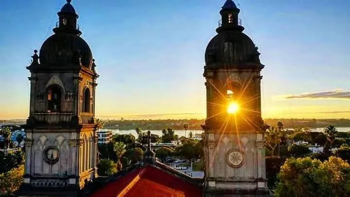 The towers of Salto cathedral against a sunset sky