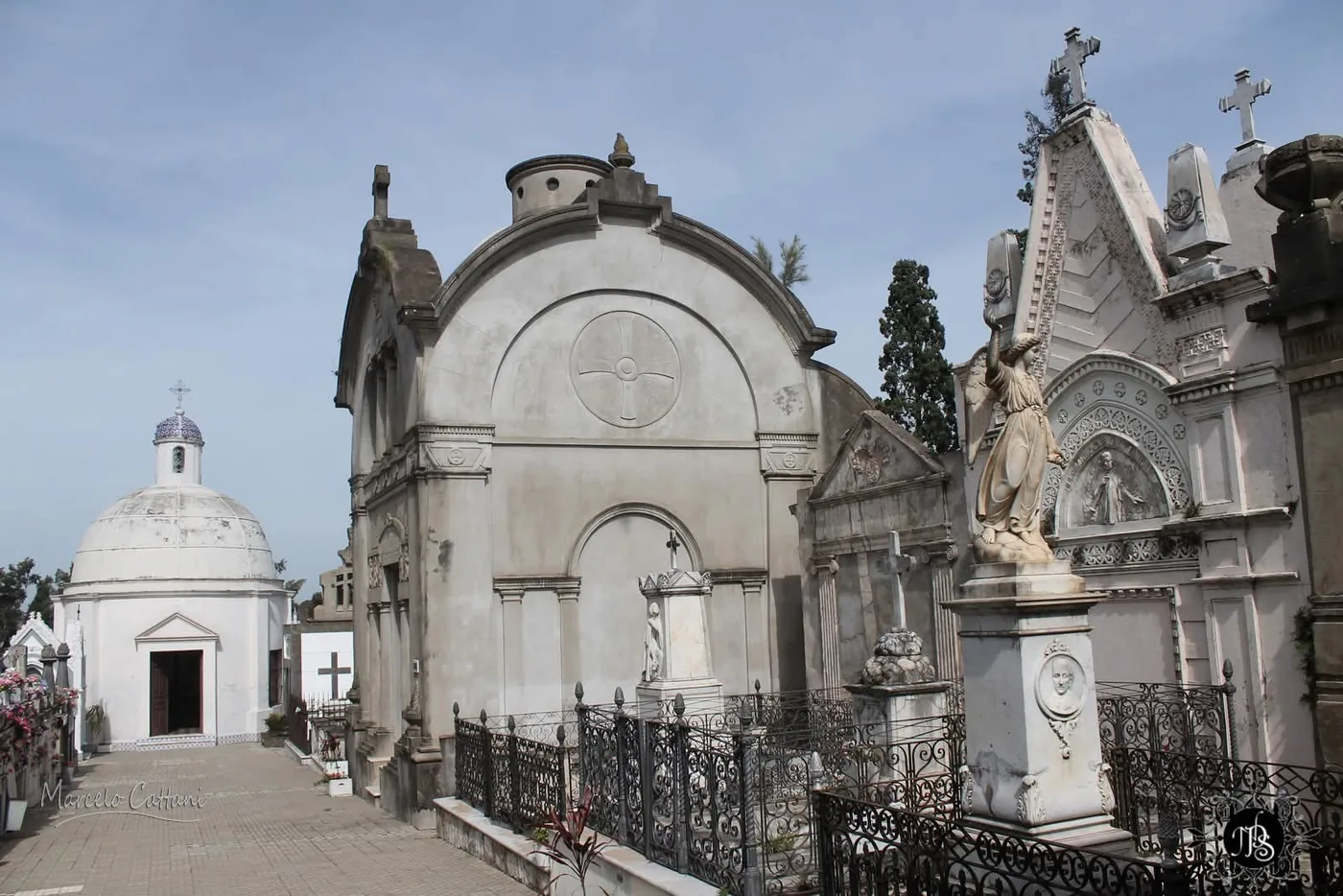 The domed central chapel and a row of mausoleums behind wrought-iron railings in the Central Cemetery of Salto, Uruguay