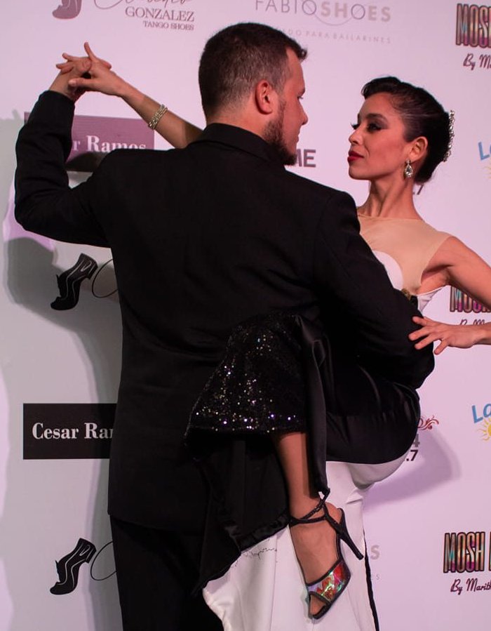 Tango in Salto, Uruguay - tango couple in a lifted figure, the dancer wrapped around her partner