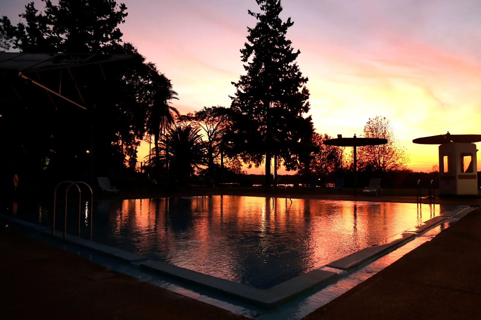 The pool of the municipal hot springs at Termas del Arapey at sunset
