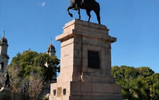 Equestrian monument to Artigas in Plaza Artigas, Salto, with the cathedral towers behind